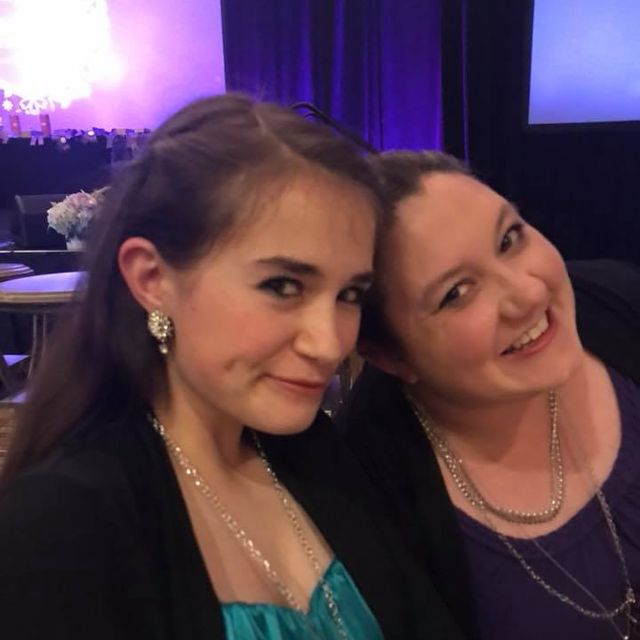 Two friends smiling together at a business convention