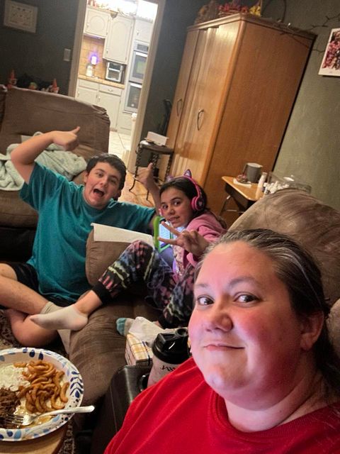 Angie takes a selfie with her son and daughter as they sit together in the living room watching election results on election night.