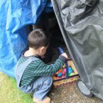 Young child searching for colorful eggs during an Easter egg hunt