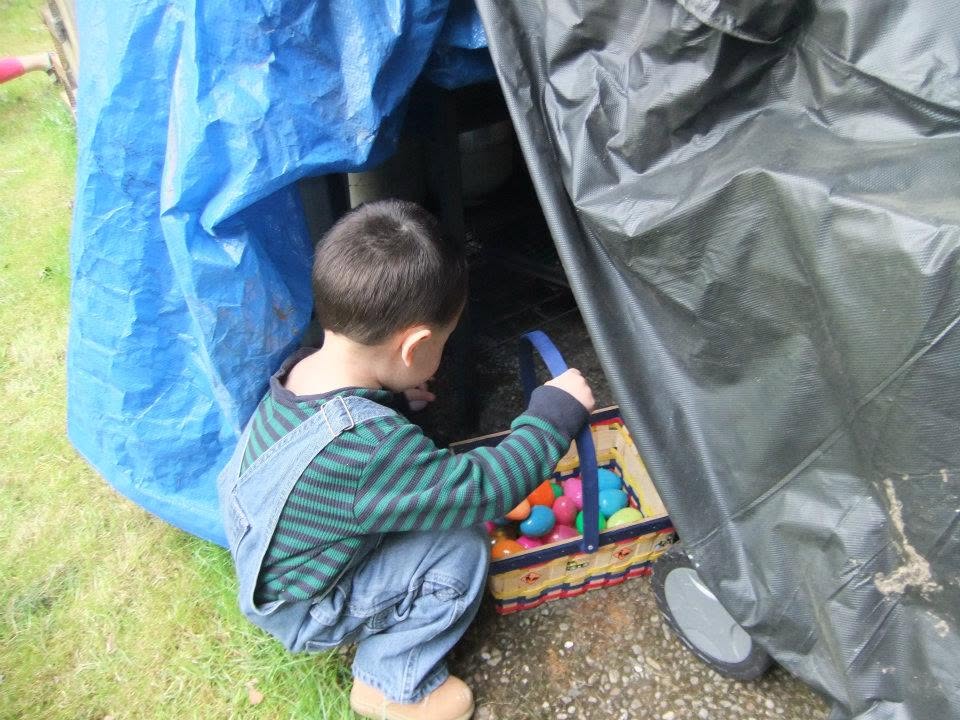 Young child searching for colorful eggs during an Easter egg hunt