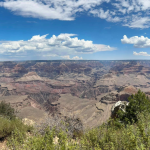 Grand Canyon landscape in Washington, with layered canyon walls stretching into the distance beneath a partly cloudy sky.