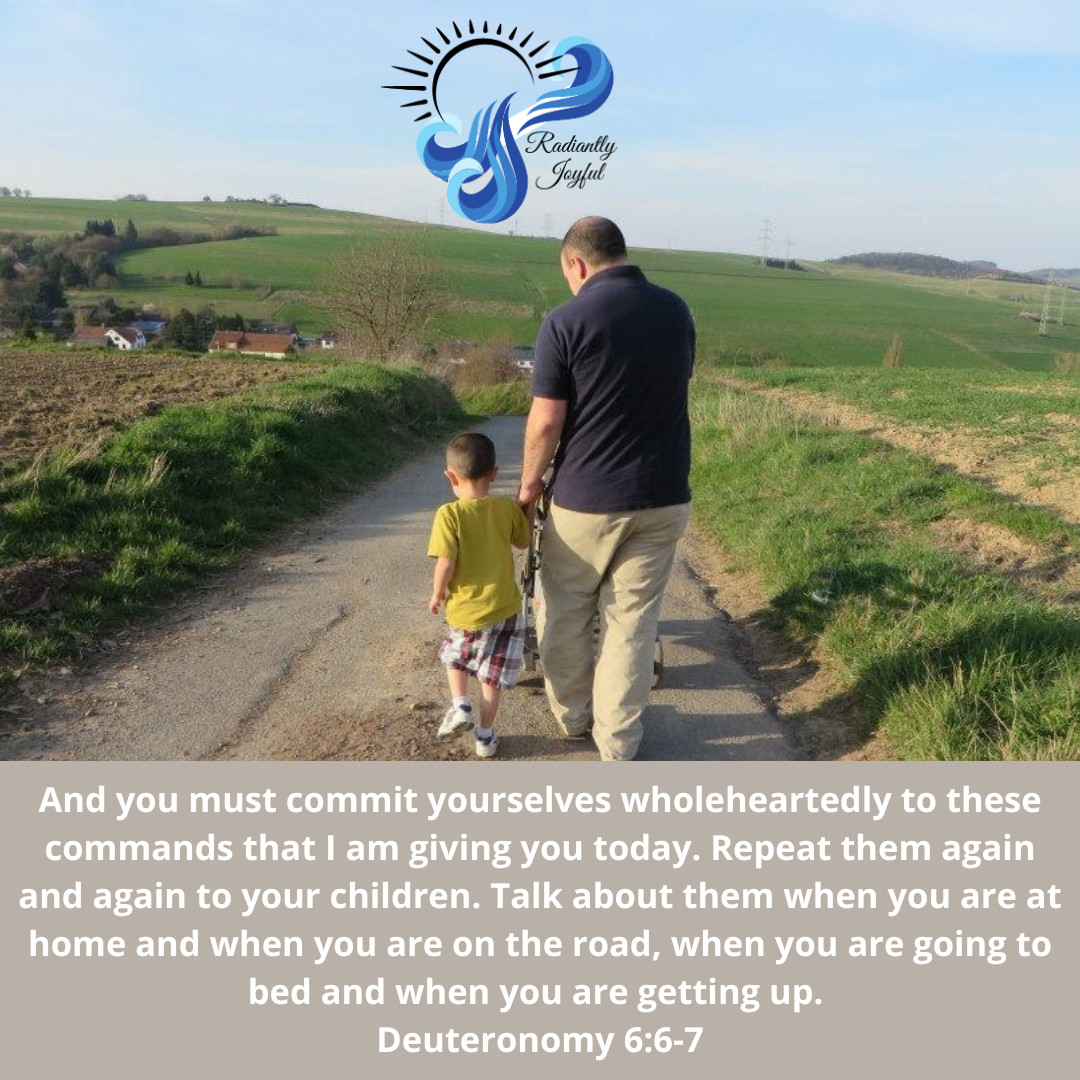 A father and young son walk together down a hill through the countryside in their German village
