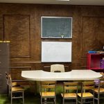 An empty Bible classroom with child-sized chairs arranged around a table, ready for students.