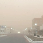 Dirt and wind storm obscuring visibility on a downtown street